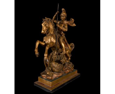 It represents St. George on horseback facing the dragon, made of carved and gilded wood, standing out for its realism and dyn