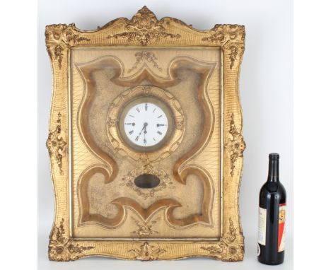 Antique Gilt Wall Clock in shadow case. Dimensions: 25.5 x 21.5 x 6 in. Framed behind glass. - All clocks are sold for displa