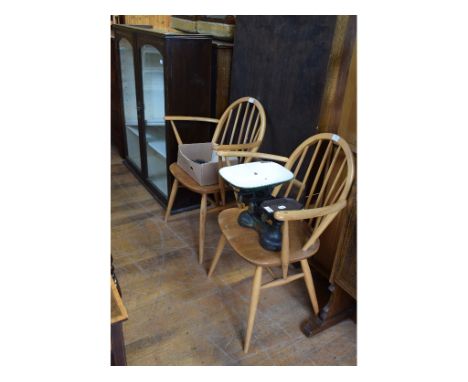 A pair of Ercol beech and elm carver chairs, a glazed bookcase, with three adjustable shelves, weighing scales and weights (5