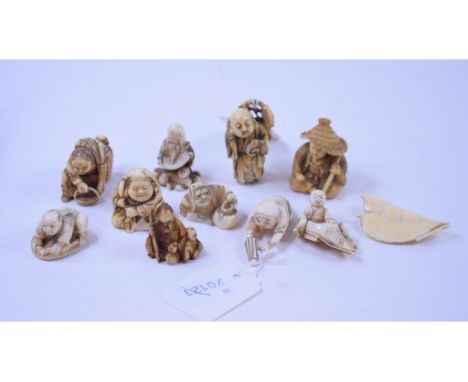 A Japanese carved ivory netsuke, in the form of two seed pods, Meiji period, 5 cm, and ten other Japanese netsukes (11) 