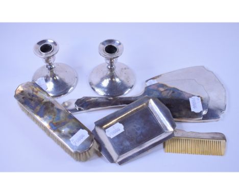 A pair of Chinese silver coloured metal dressing table candlesticks, Hung Chong, 8.5 cm high, a matching pin dish, 13.5 cm wi