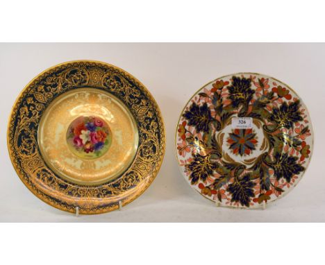 A Royal Worcester porcelain plate, with painted flower panel to centre, signed, J Stanley, within gilt borders, 27.5 cm diame