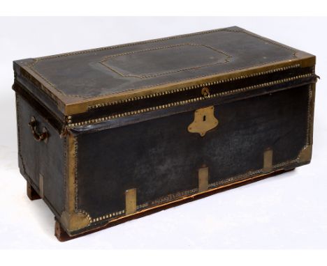 An early 19th century leather covered trunk, with brass mounts and stud work decoration, 107 cm wide  See illustration 
