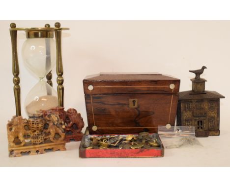 A cast iron money box, in the form of a house, 10 cm wide, a rosewood tea caddy, a barometer, cap badges, buttons, metalwares