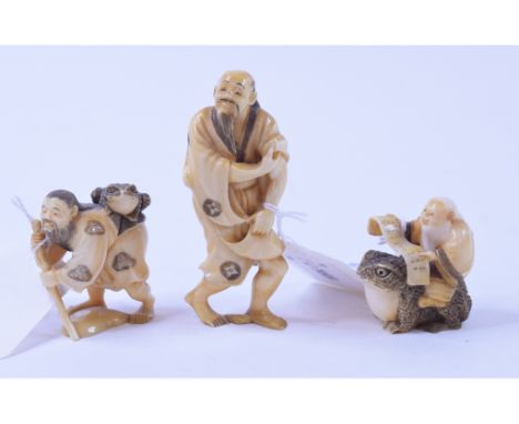 An early 20th century Japanese ivory netsuke, in the form of a man seated on a toad reading a scroll, signed, 7 cm high, anot