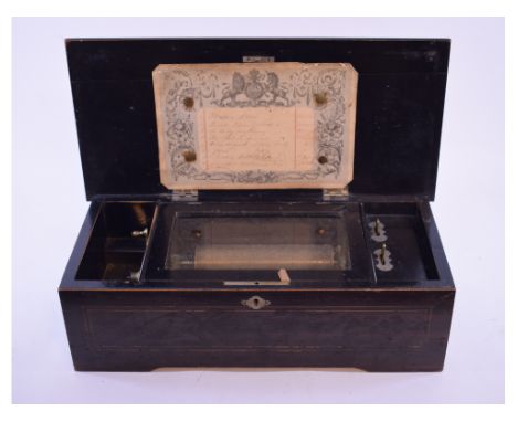 A Swiss music box, having a 16 cm comb playing eight airs, in an ebonised case, 43 cm wide 