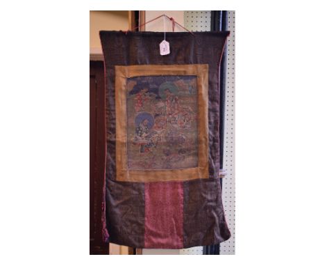 A Tibetan style thangka, decorated scholars, an elephant and a temple dog, in a fabric surround, 71 x 38 cm (overall)   Condi