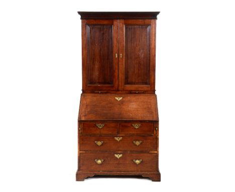 A George III mahogany bureau bookcase, the moulded corners above a pair of panel doors, enclosing adjustable shelves, with tw