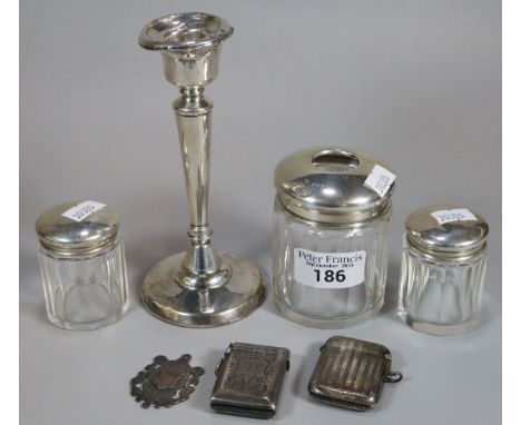 Plastic box of assorted silver items to include: single candlestick with loaded base, dressing table glass jars and silver co