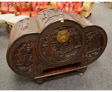 A GOOD CAMPHORWOOD ORIENTAL CHEST of tri-form and having deeply carved panels depicting sailing scenes and with brass lock pl