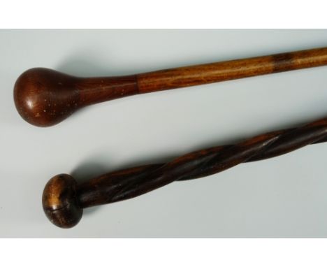 A CARVED WOODEN KNOBKERRIE-type stick with brass terminal together with a possibly South African long carved twisting staff, 