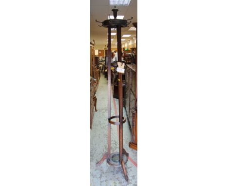 A VINTAGE CIRCULAR OAK TRIPOD COAT / UMBRELLA STAND with turned finial decoration and metal hooks, 210cms tallThe diameter at