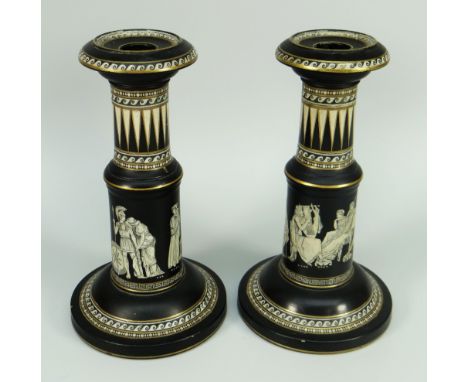 A PAIR OF BLACK BASALT CANDLESTICK HOLDERS of circular columnar form and decorated in the Neoclassical style, 23cms high