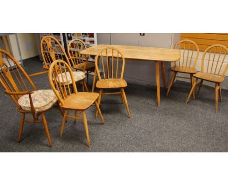 A MID TO LATE C20TH ERCOL BLONDE DINING TABLE AND CHAIR SET comprising rounded rectangular dining table with splayed supports