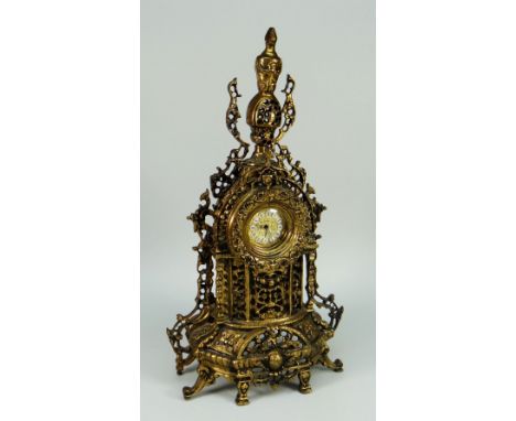 A REPRODUCTION FILIGREE GILT METAL MANTEL CLOCK
