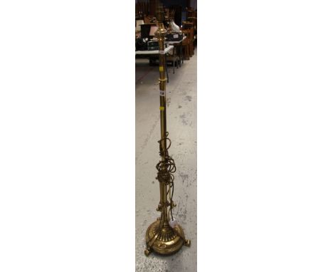 A TELESCOPIC ANTIQUE BRASS STANDARD LAMP