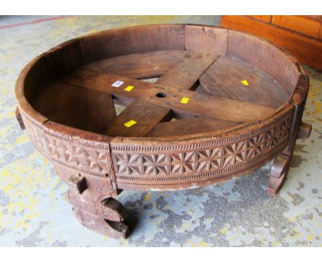 AN AFRICAN CARVED CIRCULAR SPICE GRINDER