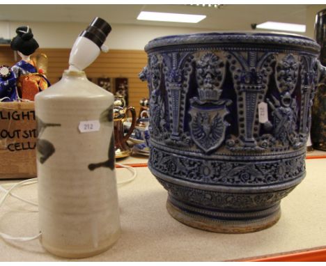 A SUBSTANTIAL GERMAN POTTERY BLUE GLAZED JARDINIERE profusely decorated with heraldic imagery and with twin wolf handles, tog