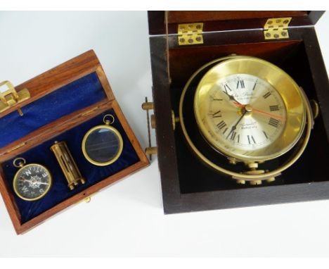 A REPRODUCTION JOHN POOLE SHIP'S CLOCK on a gimbal and in a wooden carry-case together with a cased reproduction compass egg-