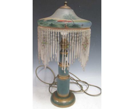 A 1920s lamp with painted glass shade and green and gold painted wooden base