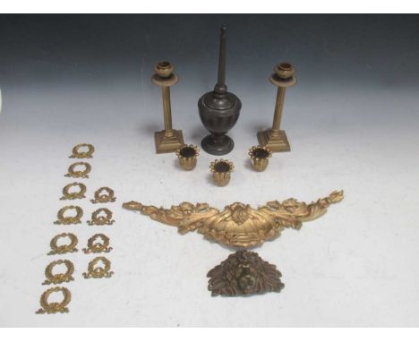 A collection of gilt bronze metal wares including a pair of brass candlesticks, furniture mounts and other items