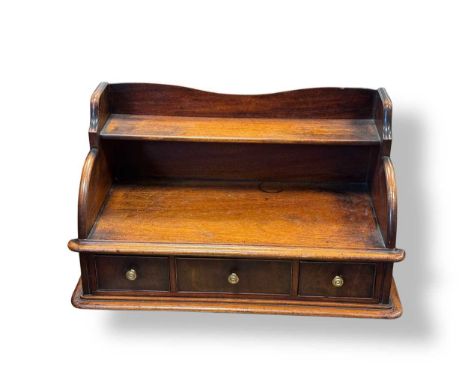 An Edwardian mahogany table top desk tidy with raised shelf and three drawer base, 30 x 54 x 25cm