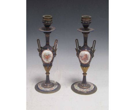 A pair of 19th century French jewelled blue enamel two handled candlesticks, one side of the baluster bodies painted with an 