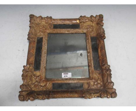 A 17th century Continental carved wood and gesso mirror or looking glass, the corners carved with flowers,38 x 35cm  Bonhams 