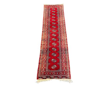 A Persian red ground runner,301 x 81cm