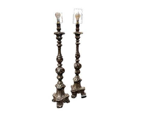 A 17th or 18th century pair of silvered and gesso pricket candlestick, converted for electricity,88cm not including fitting, 