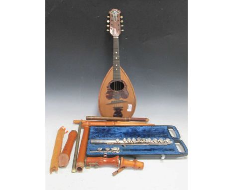 Various wind instruments to include a YAMAHA flute (incomplete), other woodwind instruments and a mandolin etc