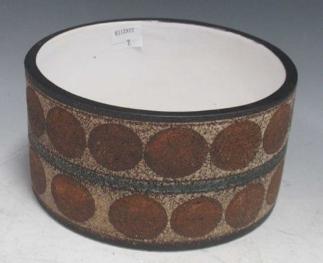 A Troika drum form bowl decorated with bands of roundels, designed by Marilyn Prudhoe, 9cm high and 16.7cm diametercrazing an