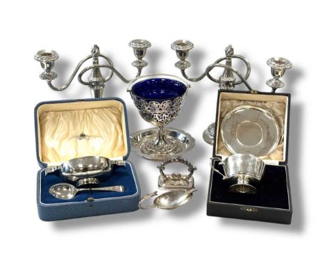 A collection of silverware including caster, ashtrays, cigarette box, cigarette case, spoon, two cased Christening sets and t