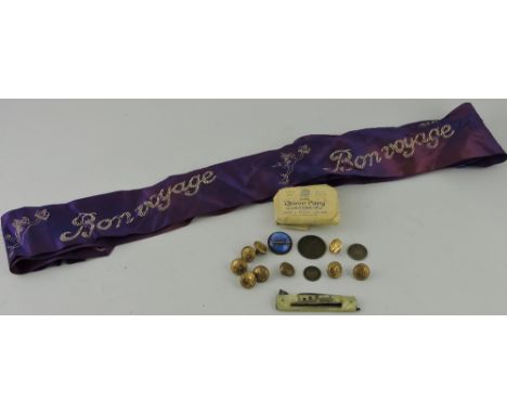 A small quantity of RMS Queen Mary ephemera, including brass uniform buttons, bar of soap and a 'Bon Voyage' sash. 