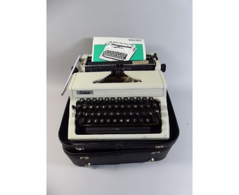 A Vintage Erika Manual Portable Typewriter with Carrying Case and Instruction Booklet
