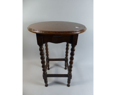 A Small Oak Circular Topped Occasional Table with Bobbin Supports, 49 cm High