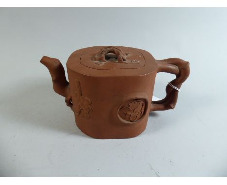 A 19th Century Oriental Terracotta Yixing Teapot with Decoration in Relief