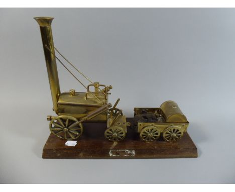 A Brass Model of Stephenson's Rocket Set on Wooden Plinth, 33 cm Long 