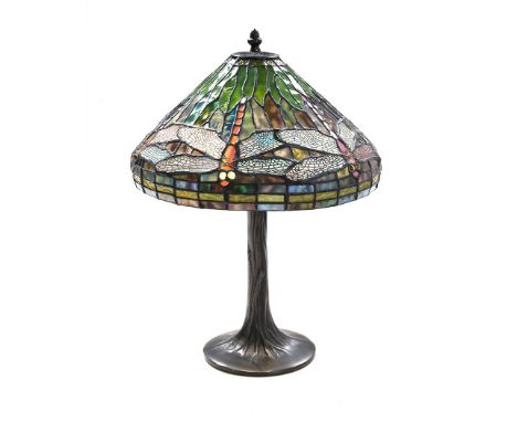  the colourful shade supported on a tapering moulded support in the form of a tree trunk, surmounted by a pine cone finial, f