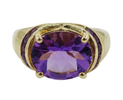 9ct gold oval amethyst ring, with round amethyst set shoulders, hallmarked