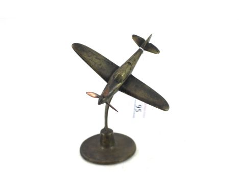 A model of a U.S.A. Airacobra fighter on brass round base