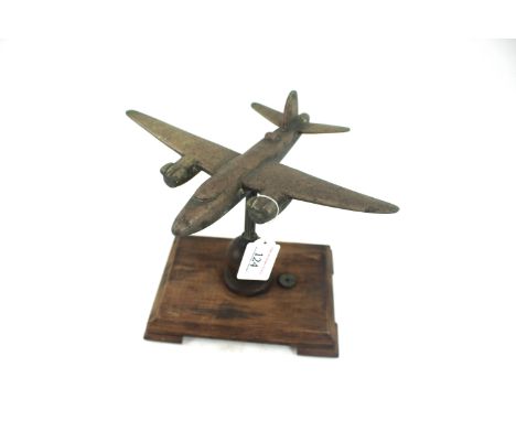 A model of a Wimpy bomber in cast brass mounted on wooden plinth