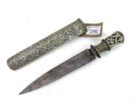 A 19th Century Tibetan ceremonial dagger with 7½" blade and profusely decorated with white metal including the scabbard