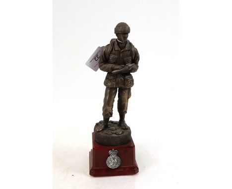 A bronzed resin figure of soldier on plinth with army cadet force badge and plaque to rear, presented to Col. P.W. Denny by W