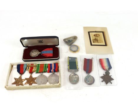 A WWII group of four medals including Africa Star with 8th Army clasp to H.L. Cook R.Sigs with his E.R.II for Efficient Servi