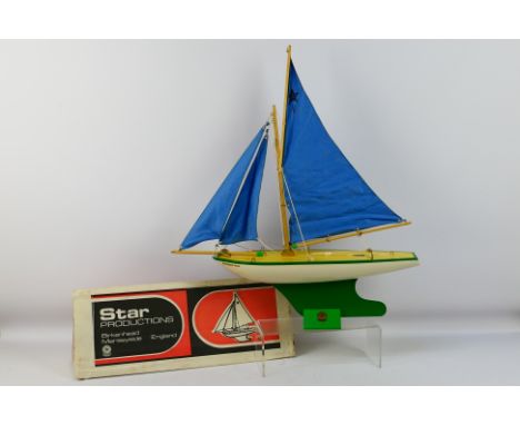 Star Yachts - A boxed vintage wooden Star pond yacht named Northern Star in white with green trim # SY5. The model shows some
