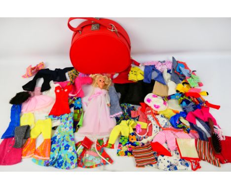 Pedigree - Sindy - An unboxed vintage Sindy doll accompanied with a red vanity case containing a large quantity of Sindy clot