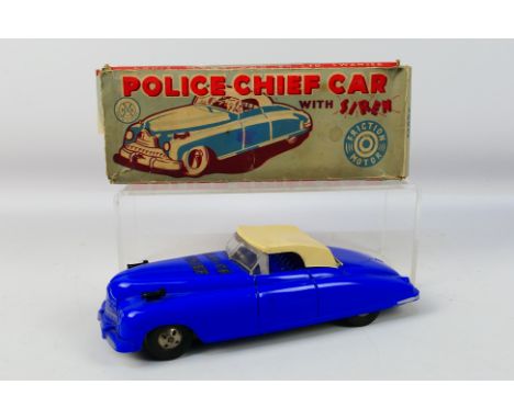 Louis Marx - A boxed Marx Police Chief Car with siren. The car appears in Good condition with some minor damage and some glue
