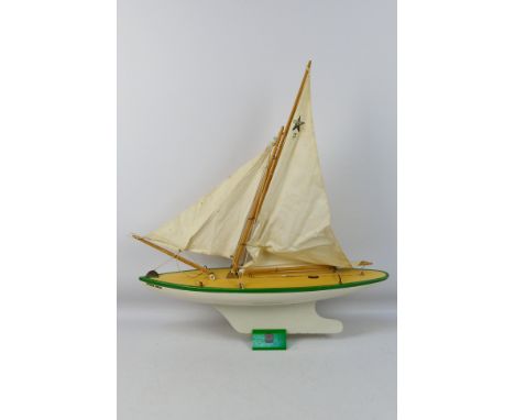 Star Yachts - A vintage wooden Star pond yacht named Ocean Star in white with green trim # SY7. The model shows some signs of