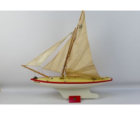 Star Yachts - A vintage wooden Star pond yacht named Ocean Star in white with red trim # SY7. The model shows some signs of a